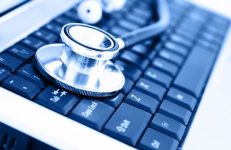 Stethoscope resting on a computer keyboard